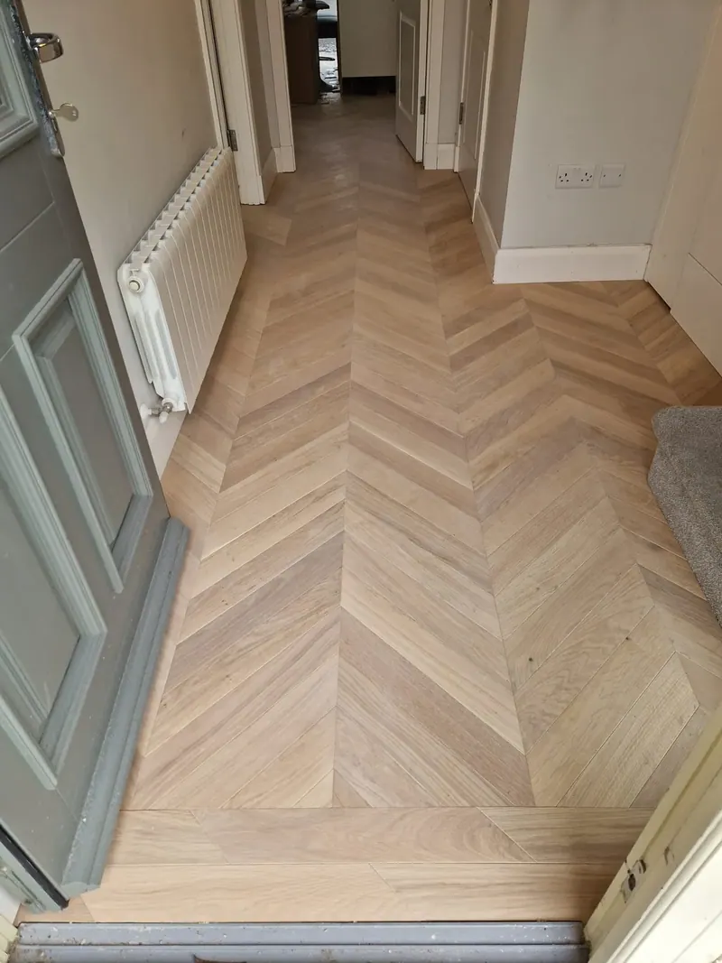 Chevron hall floor fitted neatly around a radiator