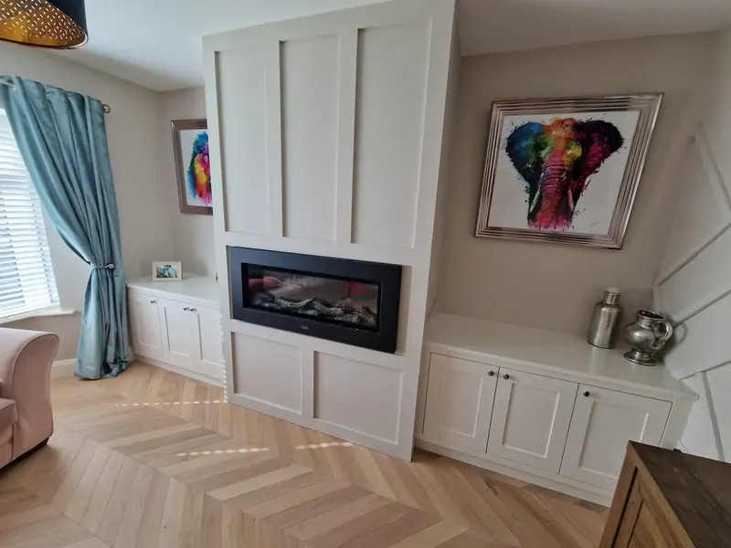 Herringbone floor in a living room with fitted alcove units