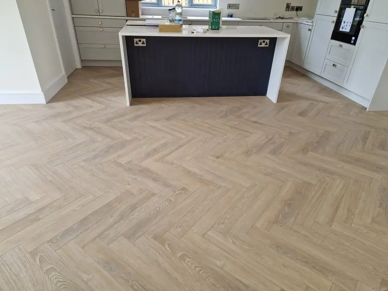Herringbone floor in a contemporary kitchen with a large island