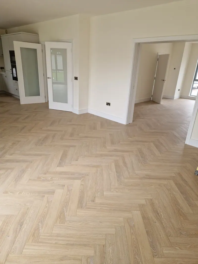 Newly laid pale herringbone in a large reception room