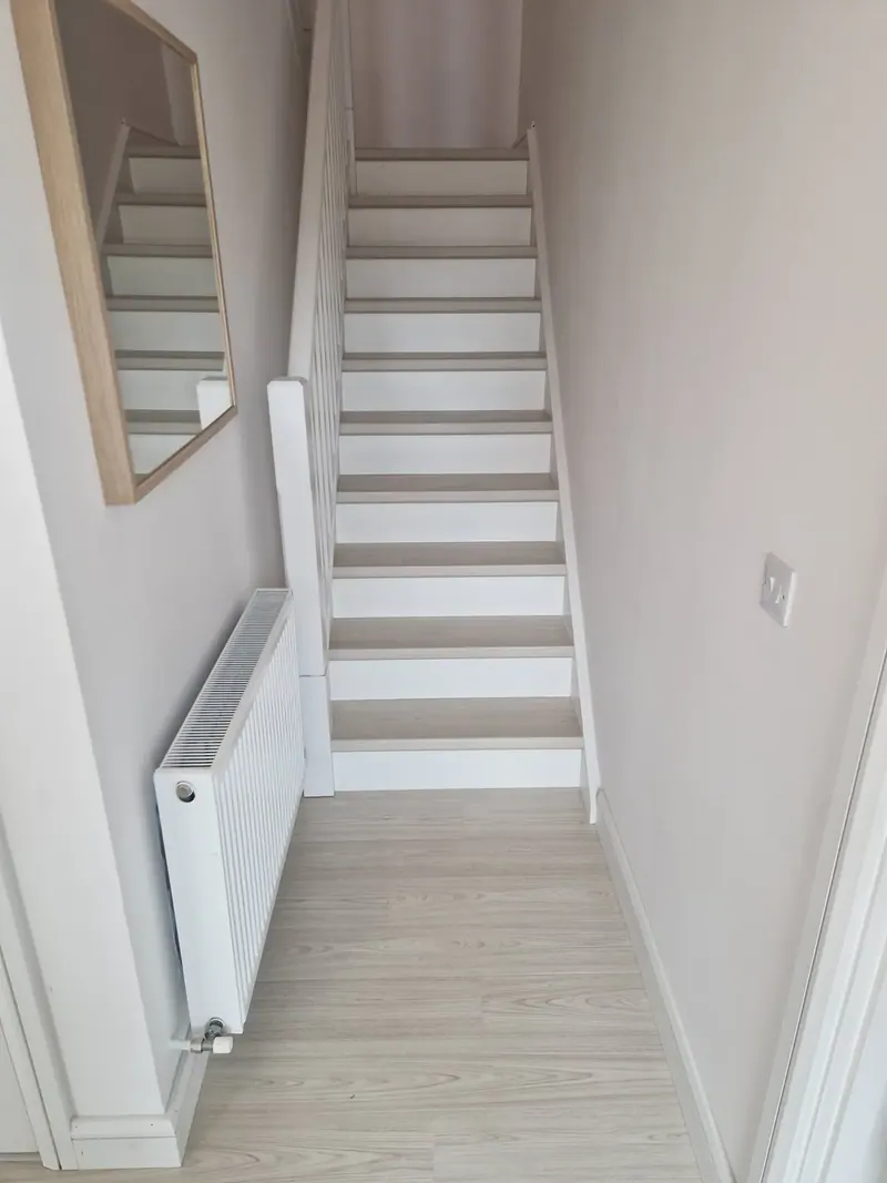 Staircase with pale timber-look treads and white risers