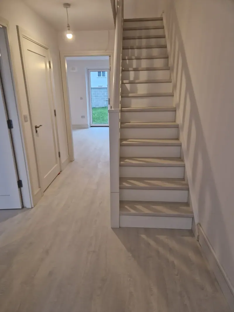 Plank floor in a hallway with matching staircase treads
