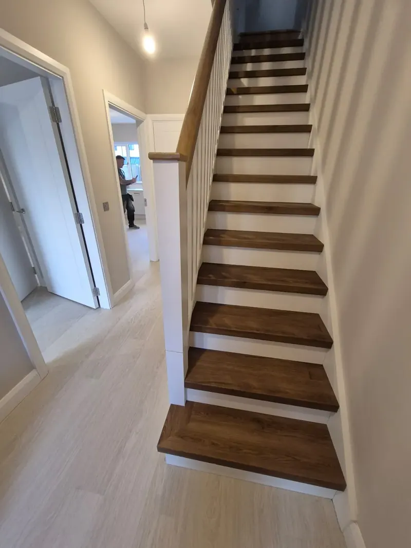 Renovated staircase with dark timber treads and white risers