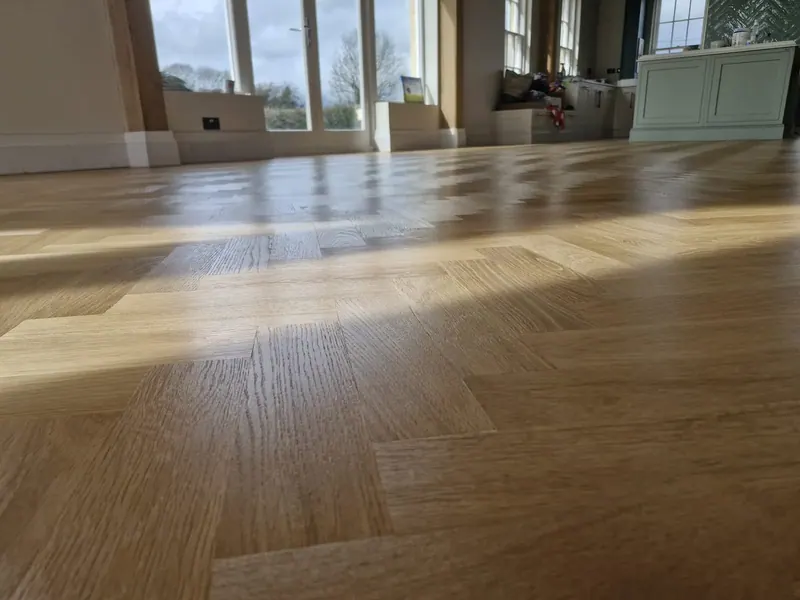 Large room with a glossy timber floor