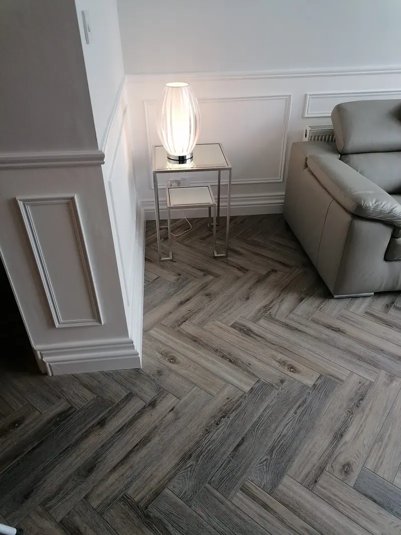 Grey herringbone floor in a panelled living room